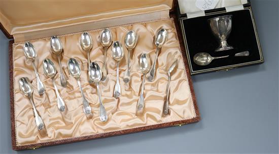 A cased set of twelve French white metal coffee spoons and a cased silver egg cup & spoon.